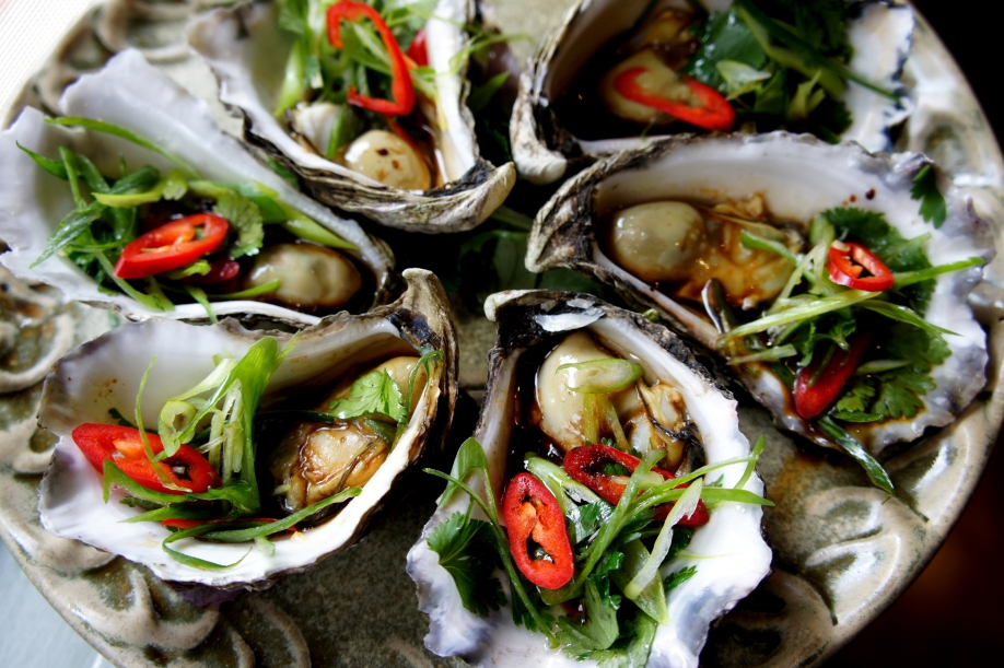 Steamed oysters with soy sauce, sesame oil, shallot, coriander and chilies